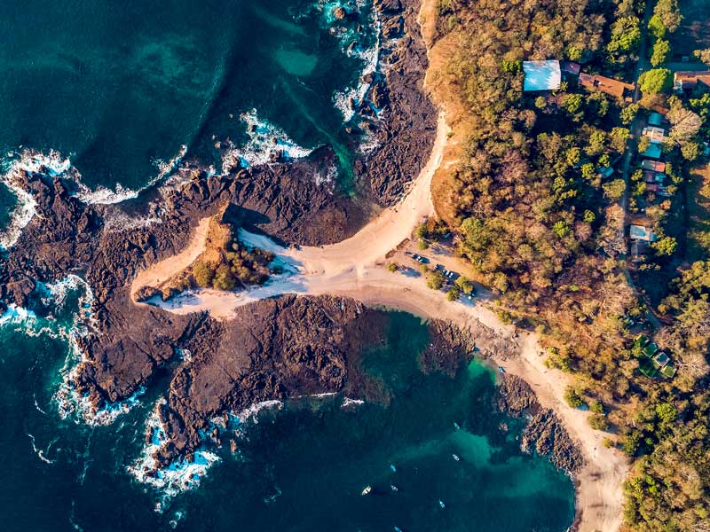 Vue aérienne d'une plage de sable et de l'océan.